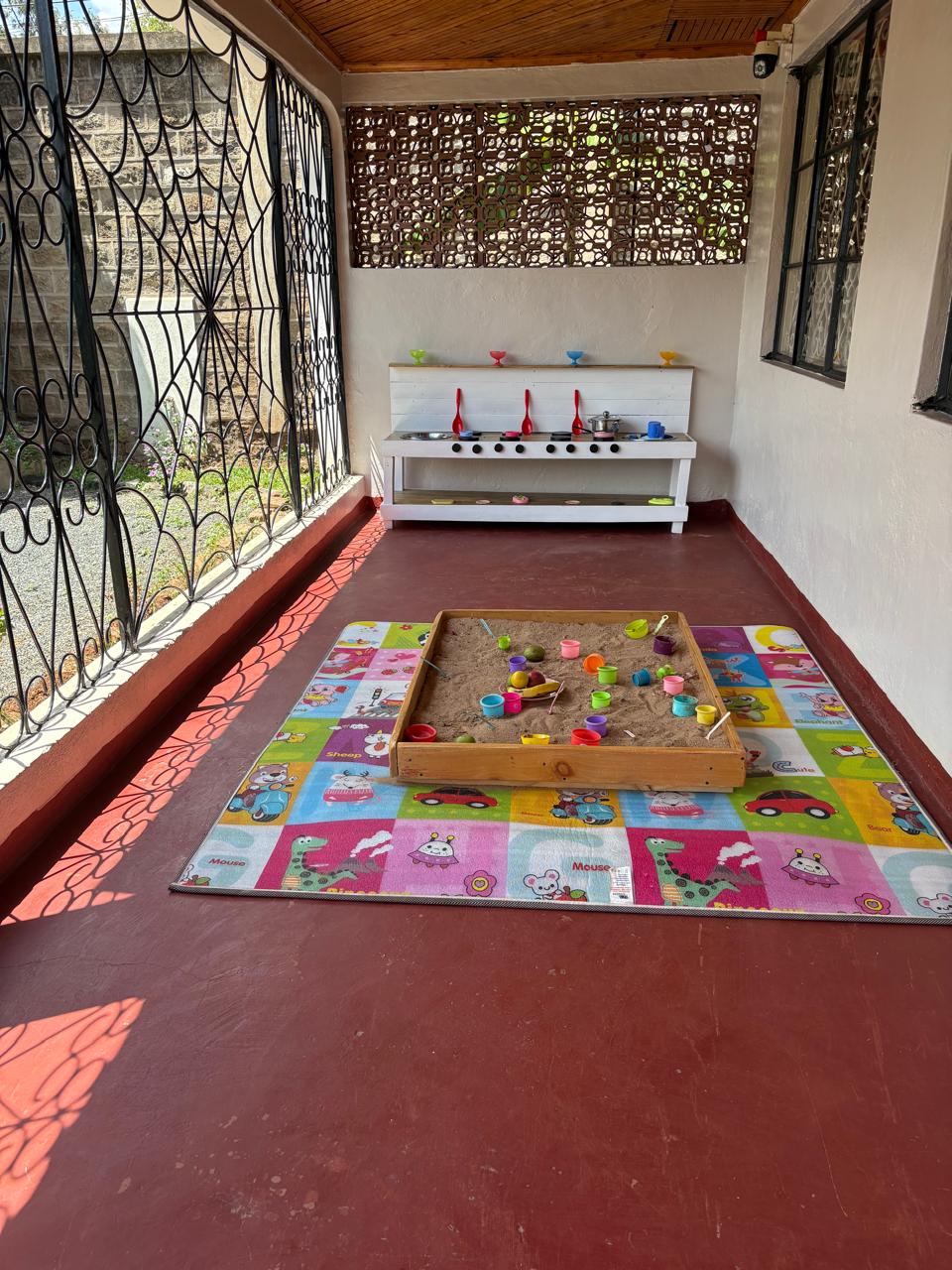 Indoor play area with sandbox and play kitchen